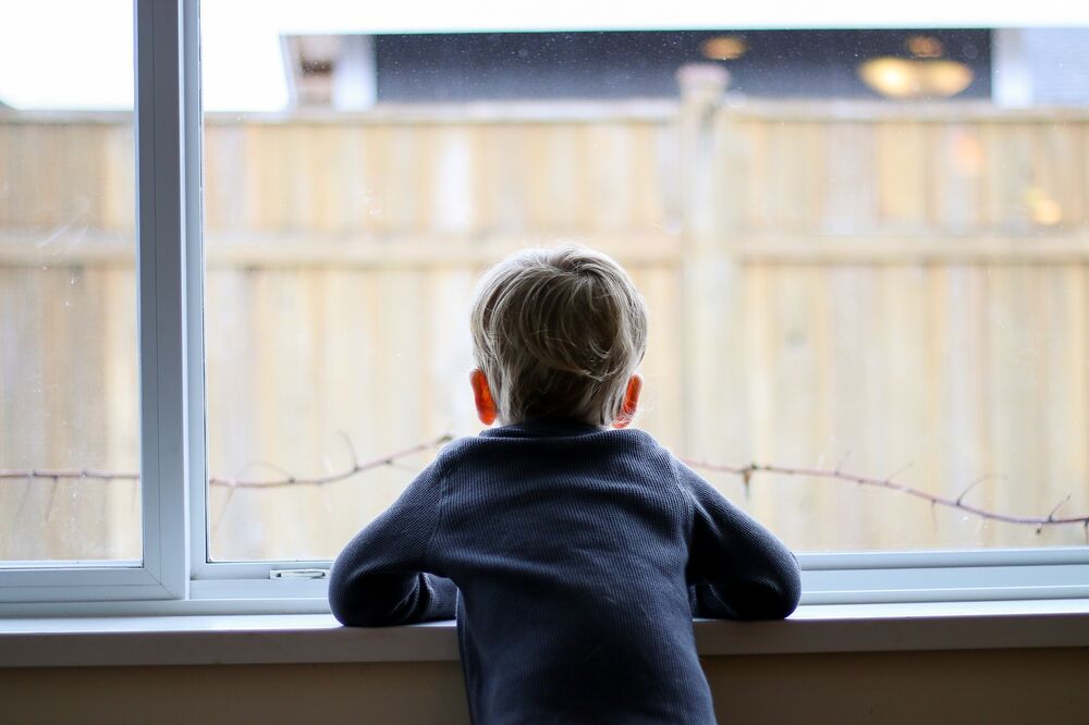 Boy looking out of window 