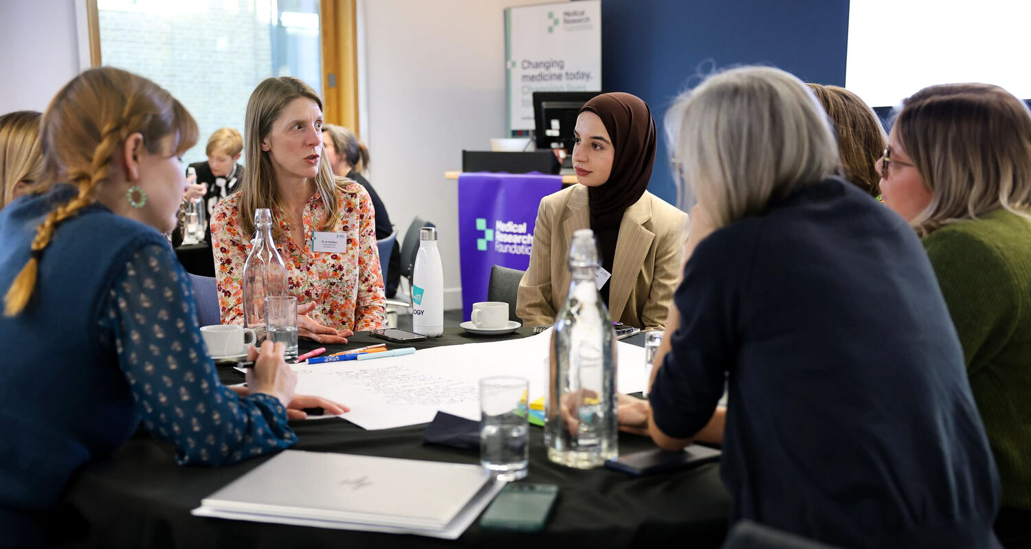 Table group discussion at eating disorders research event.