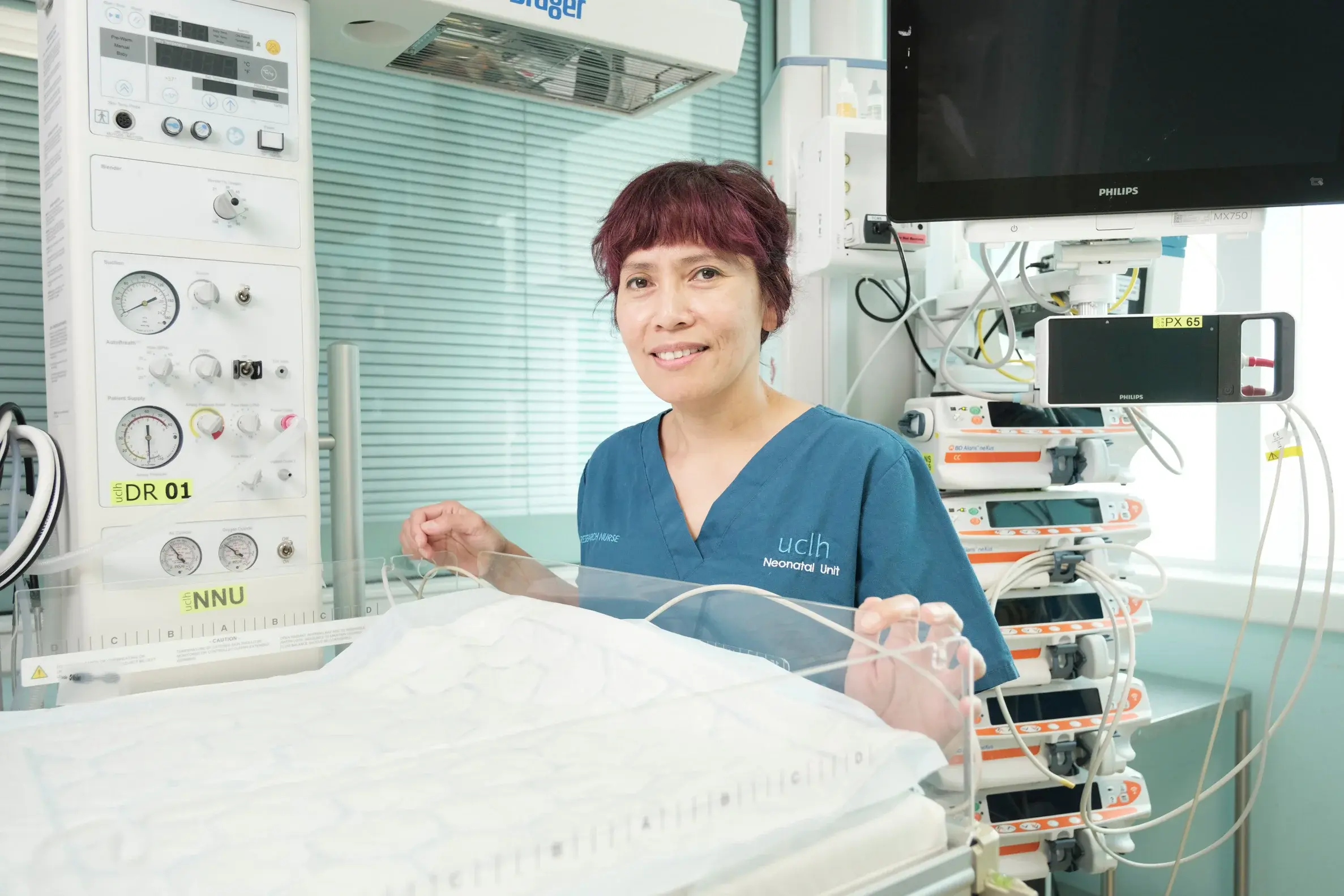 Pureza stands next to neonatal cot