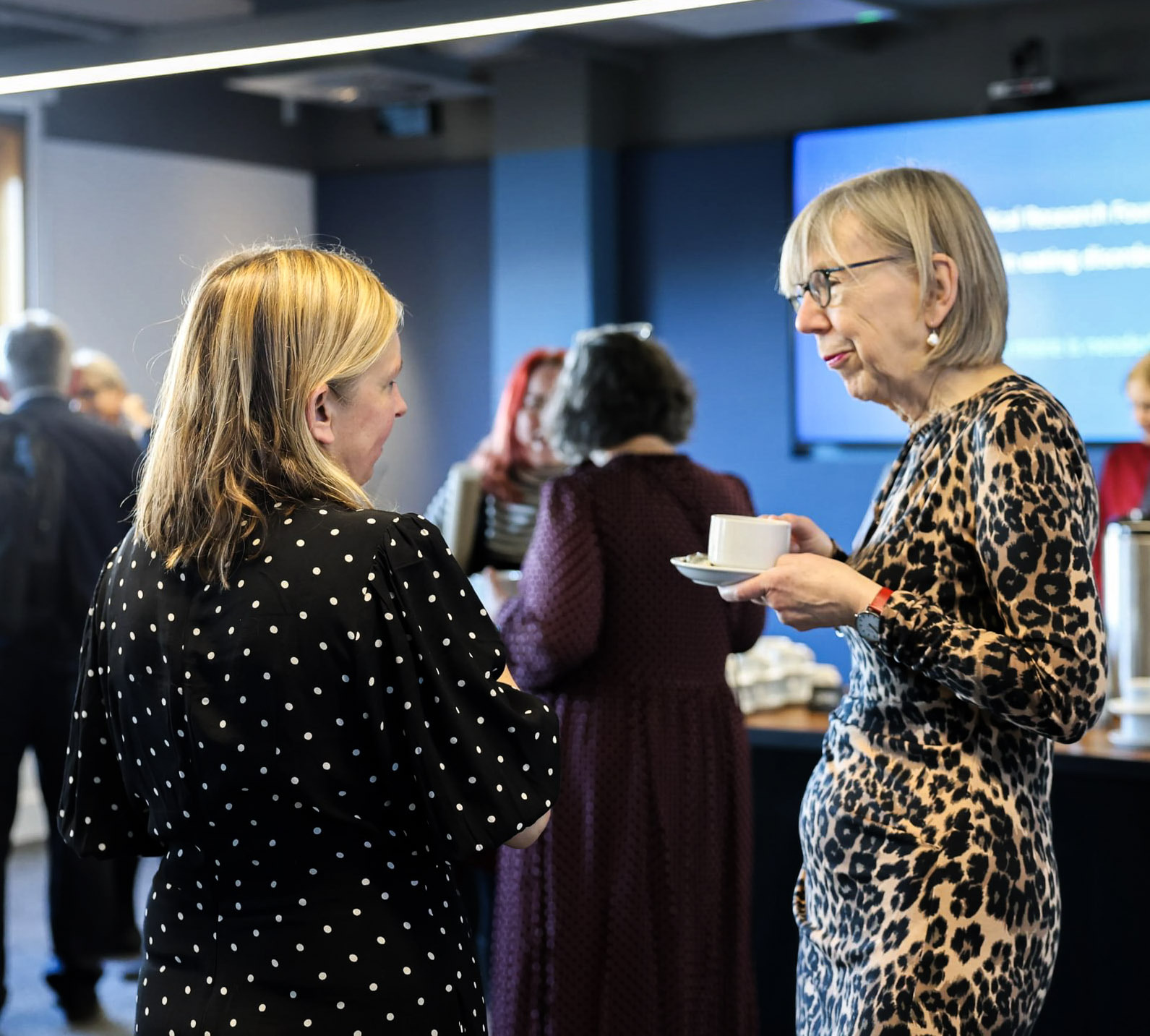 Professor Ulrike Schmidt talking to guest at eating disorders research event.