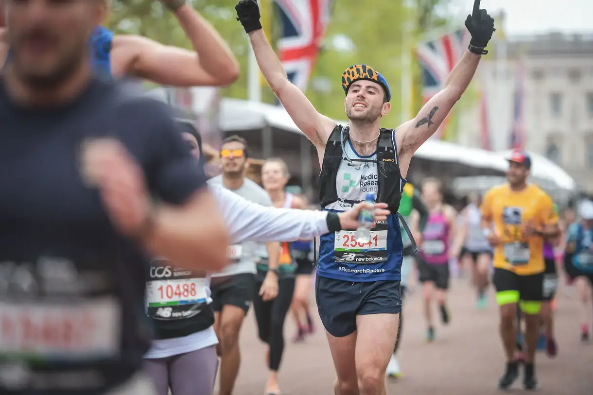 Jake Smith running the London Marathon in a Foundation-branded top