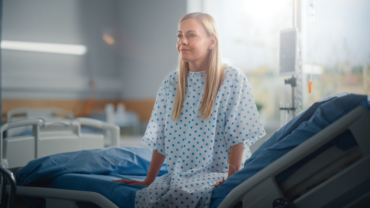 Female patient sitting on hospital bed